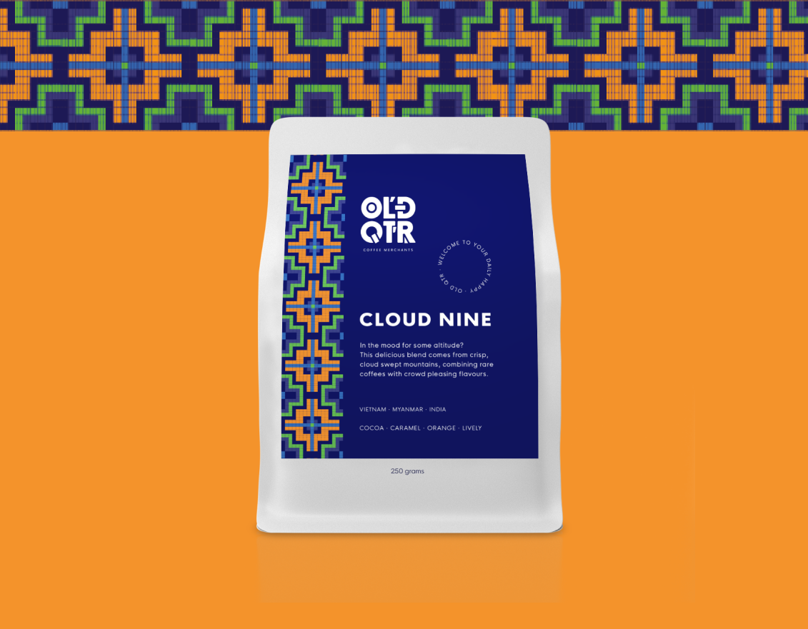 Old Quarter Coffee Merchants - Cloud Nine Blend - Medium Espresso Roast - Organic, Ethical & Direct Trade Southeast Asian Coffee - best sustainable specialty coffee, roasted in Ballina, Australia – 250g and 500g bags being held up by Amelia